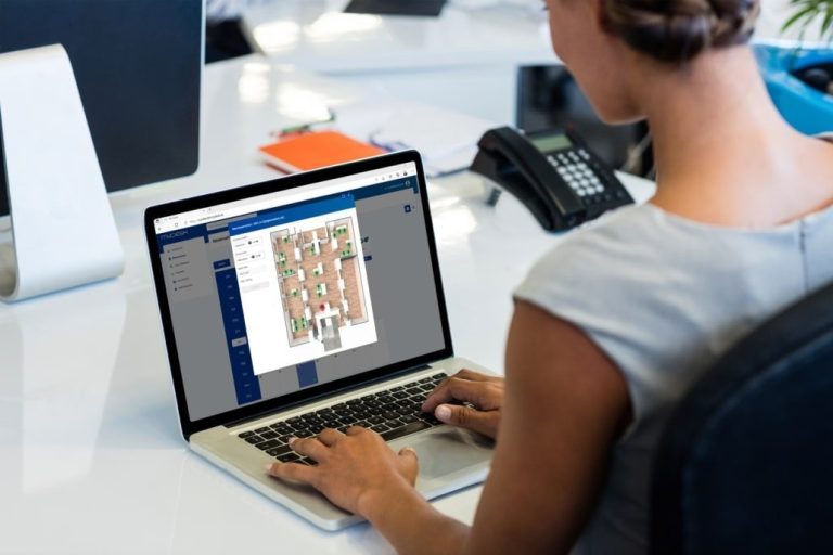 Women at laptop with MyDesk floorplan
